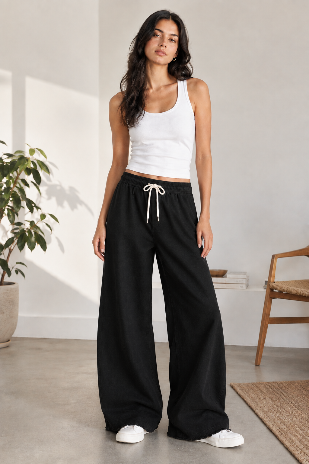Woman modeling Eastrobe stretch wide-leg jeans in the XS–L fit